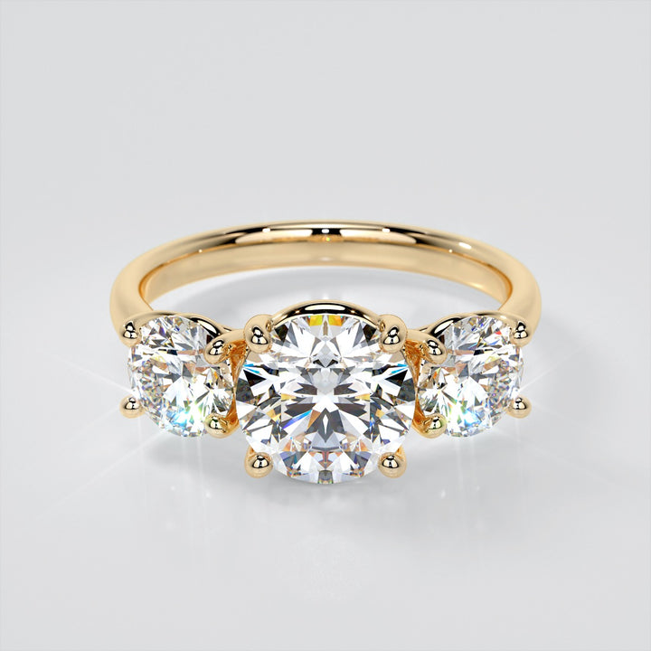 Round Cut Three-Stone Engagement Ring With Accents