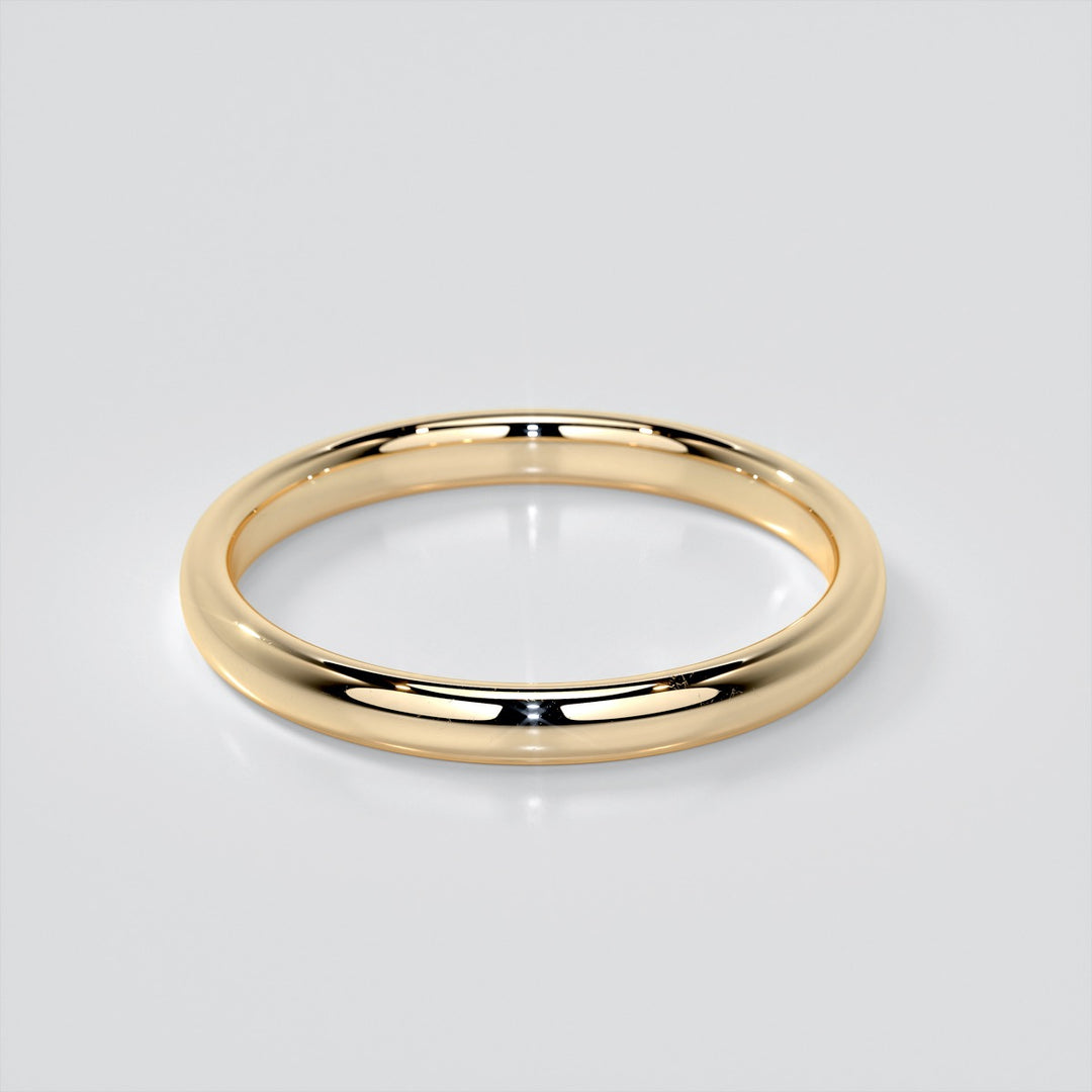 Gold ring on a light gray background