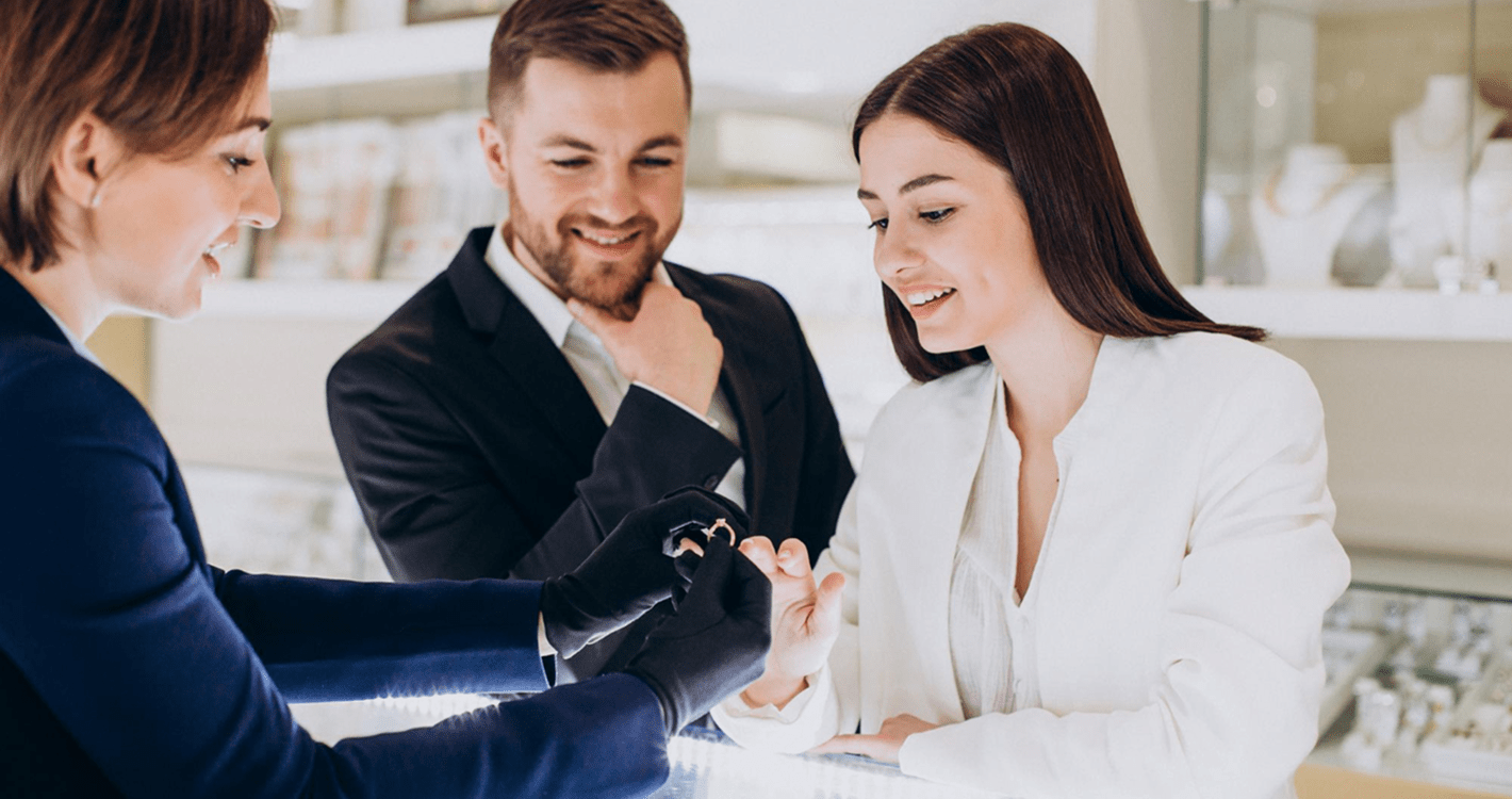 Two women and a man interacting in an office setting