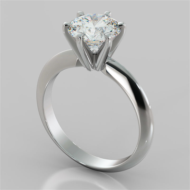Silver ring with a heart-shaped diamond on a gray background