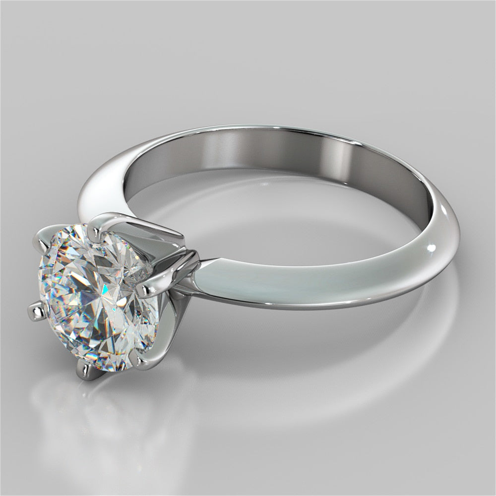 Silver ring with a large diamond on a gray background