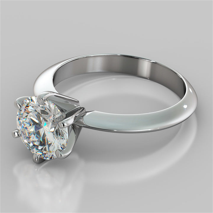 Silver ring with a large diamond on a gray background