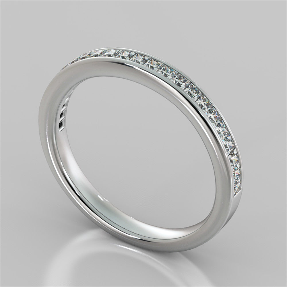 Silver ring with small diamonds on a gray background