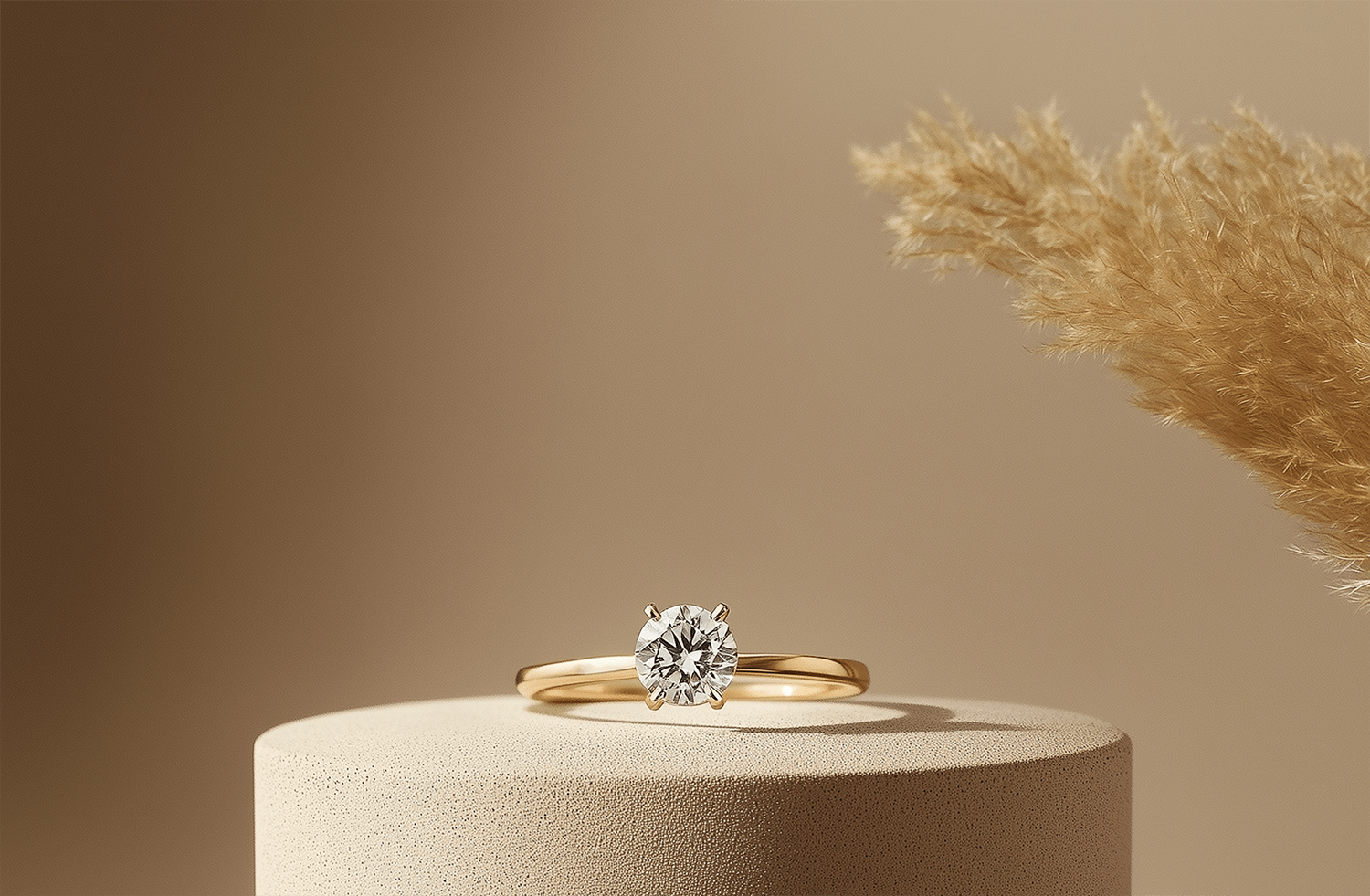 Gold ring with a diamond on a beige pedestal against a brown background