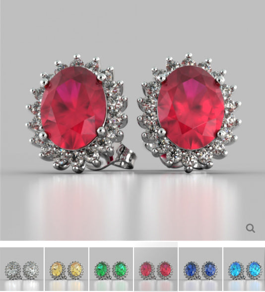 Pair of earrings with red gemstones and silver settings on a gray background