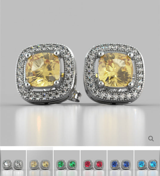 Pair of earrings with yellow gemstones and silver accents on a gray background.