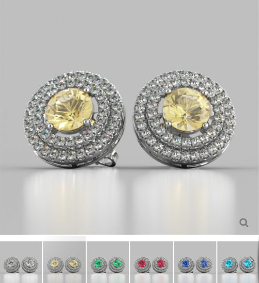 Pair of round earrings with yellow gemstones and clear stones on a gray background.