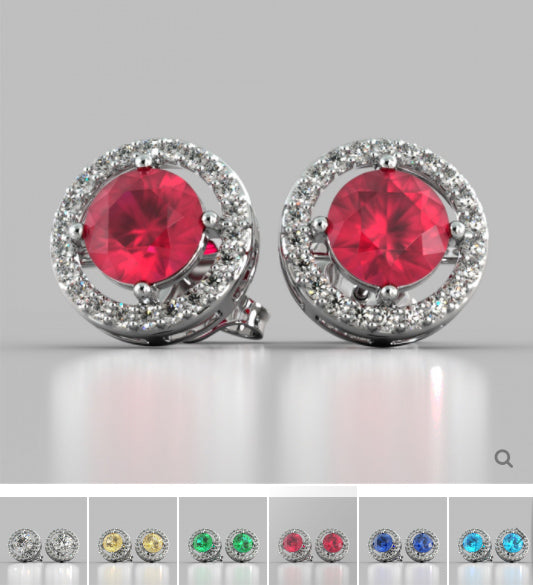 Pair of earrings with red gemstones on a gray background