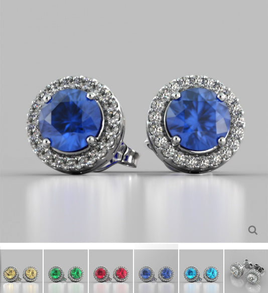 Pair of blue gemstone earrings with silver halo on a gray background