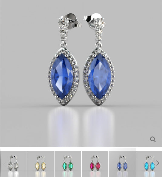 Pair of blue gemstone earrings with silver accents on a gray background