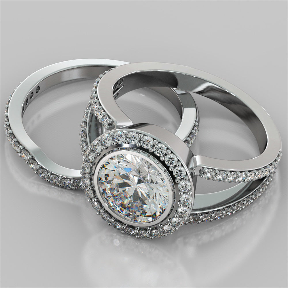 Two silver rings with diamond accents on a gray background