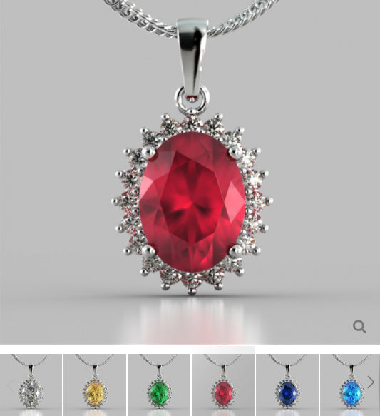 Silver pendant with a red gemstone on a gray background