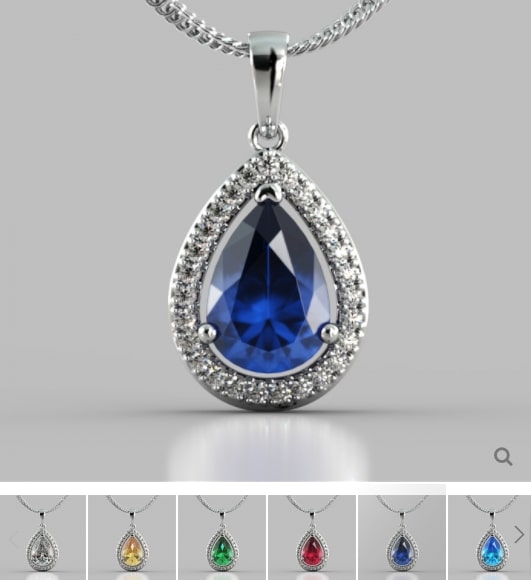 Teardrop-shaped pendant with blue gemstone and silver frame on a gray background