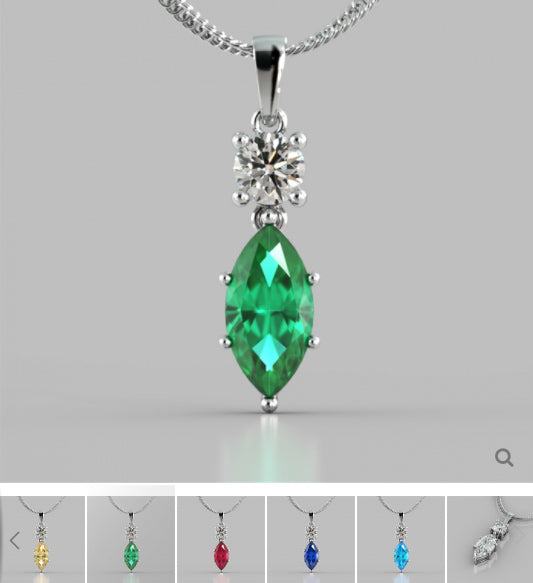 Green gemstone pendant with silver chain on a gray background