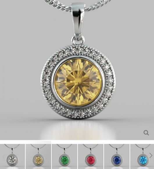 Silver pendant with a yellow gemstone on a gray background