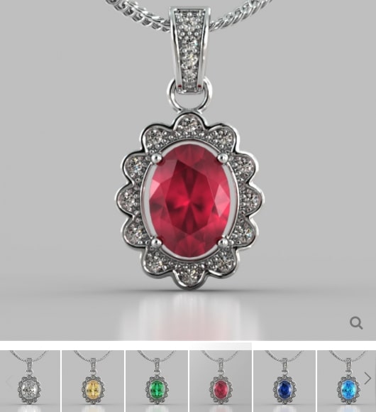 Silver pendant with a red gemstone on a gray background