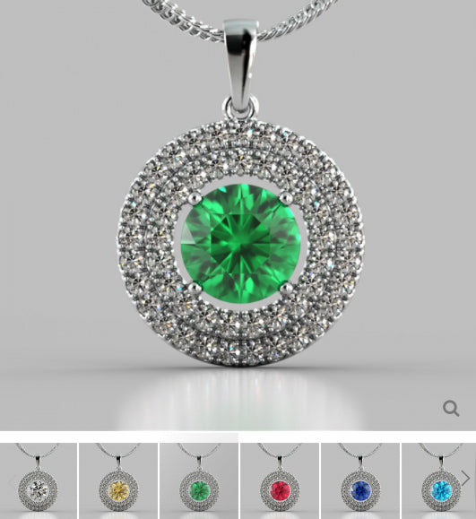 Silver pendant with a green gemstone on a gray background