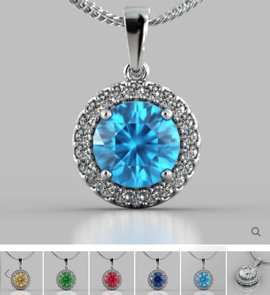 Silver pendant with a blue gemstone on a gray background