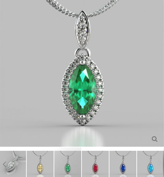 Silver pendant with a green gemstone on a gray background