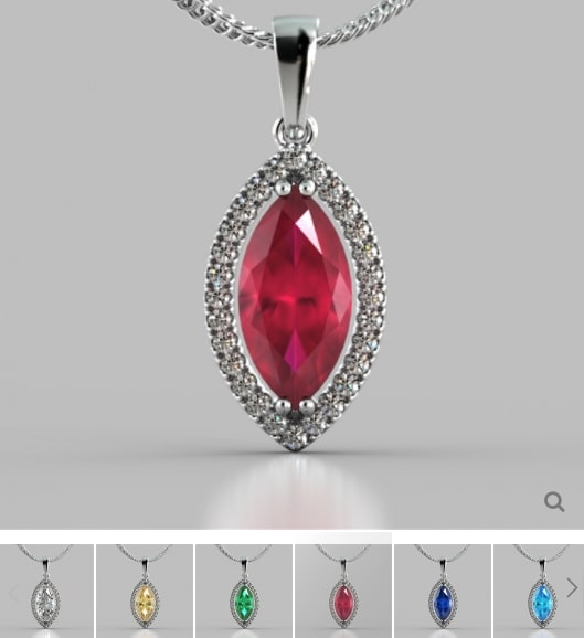 Silver pendant with a red gemstone on a gray background