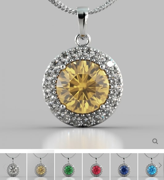 Silver pendant with a yellow gemstone on a gray background