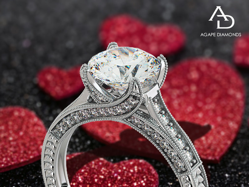 Elegant diamond ring with red heart-shaped objects in the background, featuring the Agape Diamonds logo.