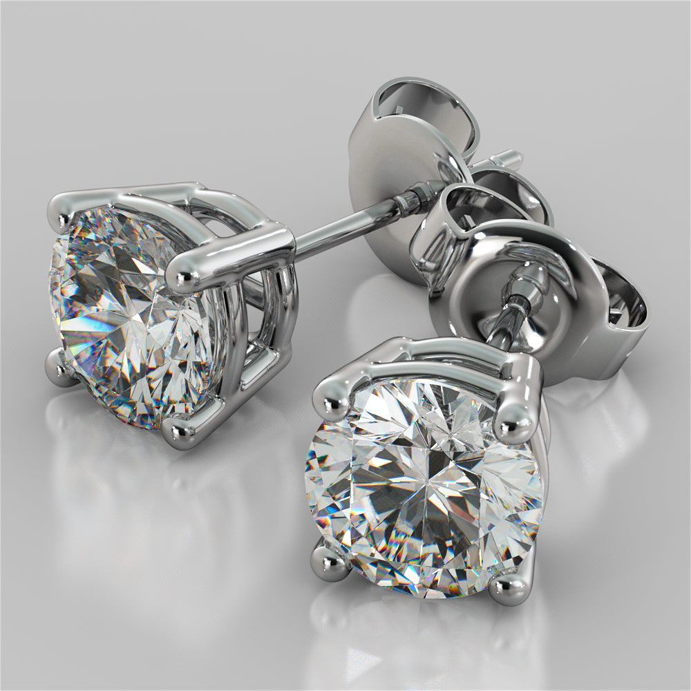 Pair of diamond stud earrings on a light gray background