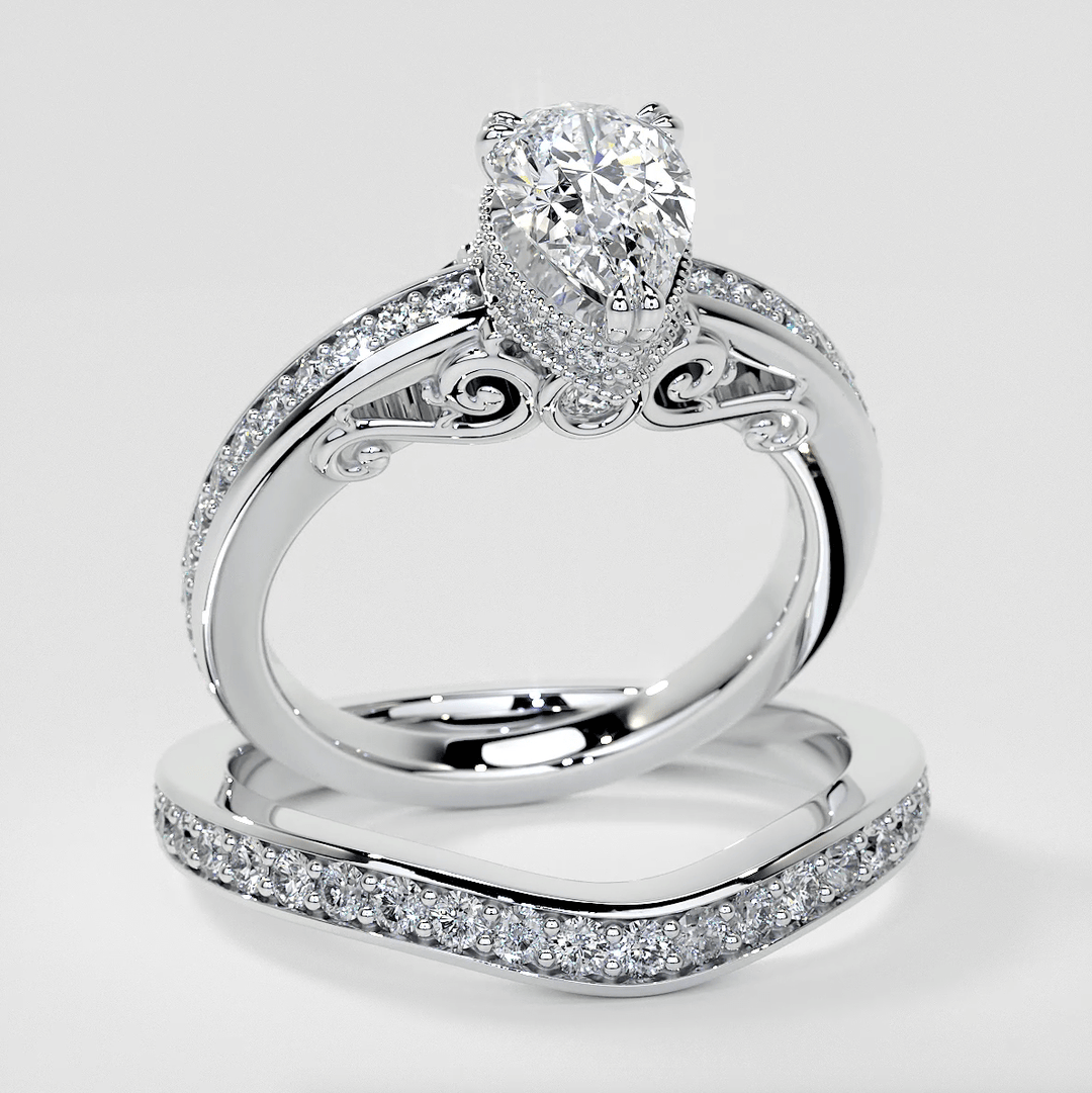 Silver ring with a pear-shaped diamond and smaller diamonds on a white background